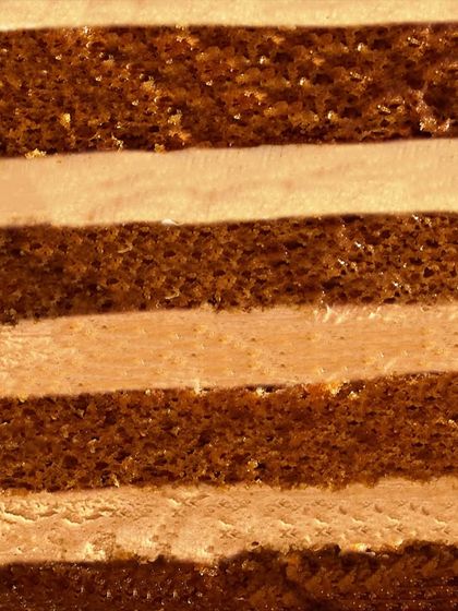 A close-up of the layers inside my Caramel Cake. The alternating light sponge and creamy caramel-infused buttercream create a beautiful striped effect.