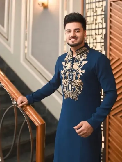 A royal blue kurta with gold embroidery on the chest and collar, perfect for Eid or a sangeet.