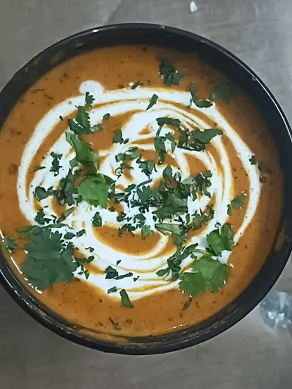 A bowl of my rich and creamy Kadai Paneer, garnished with fresh cream and coriander. It's a perfect dish for any special meal.