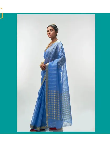 Another side view of the cornflower blue saree, emphasizing its serene color and elegant drape.