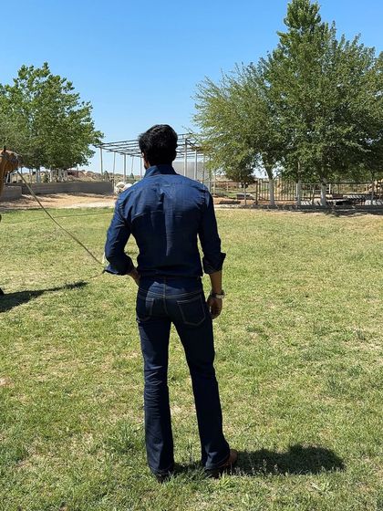 This image captures the complete denim look in a rustic, open-field setting, emphasizing its adventurous and masculine appeal.