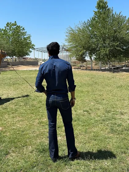 This image captures the complete denim look in a rustic, open-field setting, emphasizing its adventurous and masculine appeal.