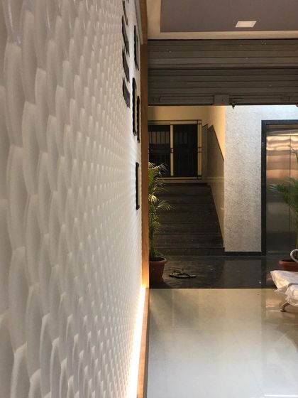 The hallway in the clinic is kept bright and professional, with clean lines and reflective flooring.