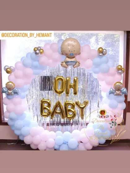 An "Oh Baby" themed decoration perfect for a baby shower or gender reveal party. The circular backdrop is made of pastel pink and blue balloons, with a baby foil balloon at the top.