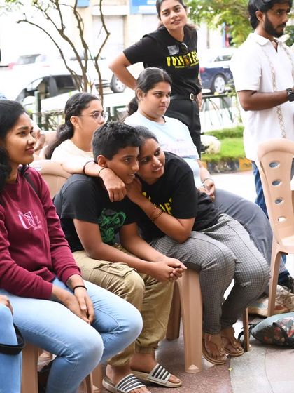 A moment of connection and support between two participants at Sign Fest. Our events create a safe and welcoming space for everyone to be themselves.