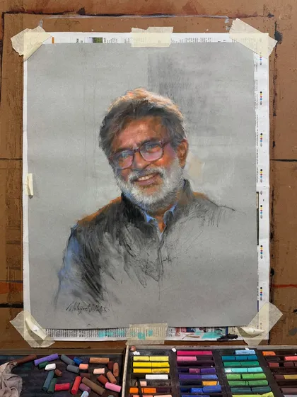 The portrait of Mr. Vasudeo Kamath on my easel, with the soft pastels I used to create it.