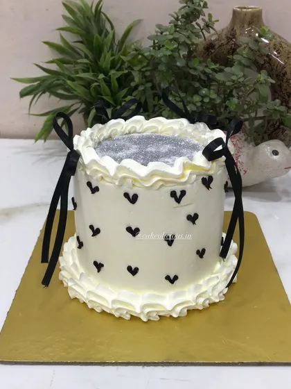 A chic glitter cake with black hearts and delicate black ribbon bows. This design is simple, modern, and perfect for a stylish birthday or bachelorette party.