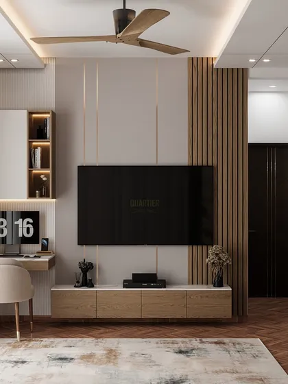 The TV and workstation area of the same master bedroom. The design is clean and functional, with a mix of wood tones and neutral colors.
