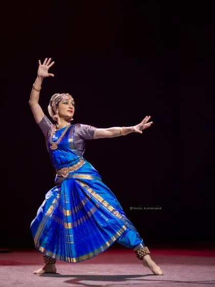 A wide stance that shows the grounded yet fluid nature of the dance form. The arms are extended, as if embracing the space.