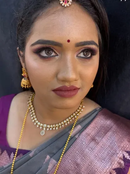 A stunning reception look with smoky purple eyeshadow and a matte mauve lip, perfect for an evening event.