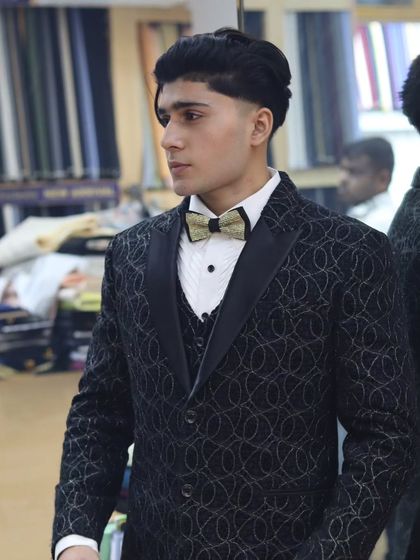 A client looking sharp during his suit trial. This black patterned tuxedo is designed to fit perfectly, ensuring he looks and feels his best for his special occasion.