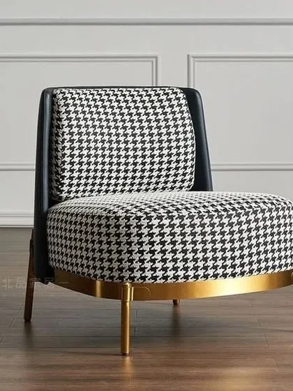 We selected this classic houndstooth pattern armchair for a client's living room. The bold fabric combined with the brass-finished base adds a touch of timeless elegance.