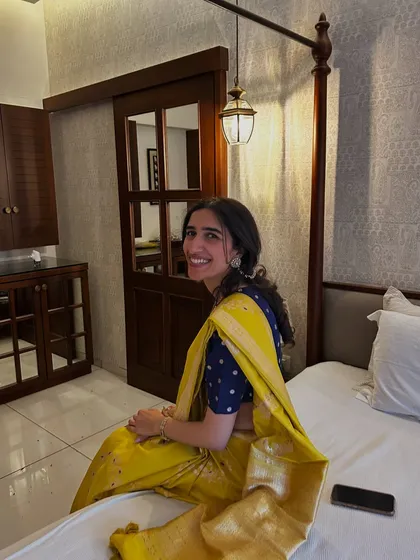 A candid moment showing the joy that comes from wearing something meaningful. Styling with heirlooms is not just about fashion; it's about carrying forward a legacy with pride and happiness.