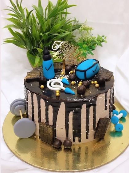 A perfect gym-themed cake for a fitness lover with a sweet tooth. This chocolate drip cake is loaded with fondant gym equipment like dumbbells, a shaker, and weights.