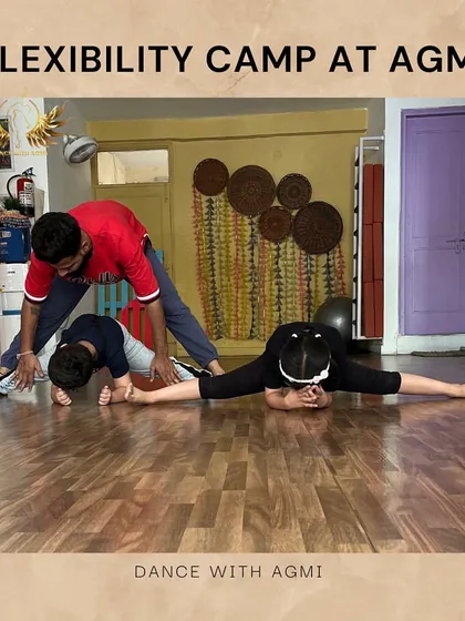 An instructor helps two students in the flexibility camp with a partner oversplit. This advanced technique helps them achieve a greater range of motion safely.