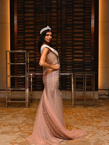 A side profile showcasing the elegant hairstyle and the beautiful silhouette of the gown. Every detail matters for pageant-level glam.