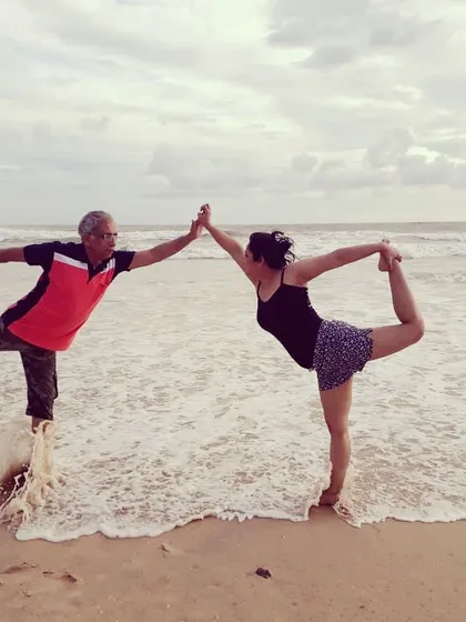 Yoga is a family affair for us. Here I am practicing a partner Natarajasana (Dancer's Pose) with my daughter on the beach. We teach together, bringing our combined experience and a supportive family feel to every class.