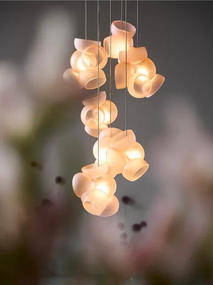 A small cluster of Bocci 100 pendants is captured with a soft, blurred background, making the lights appear as if they are floating in a dream.