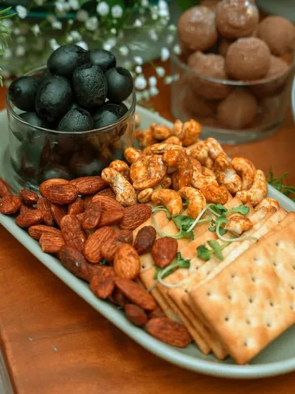 A simple yet elegant platter of seasoned nuts, crackers, and olives. This is a perfect accompaniment to any of our larger grazing tables or as a standalone snack.