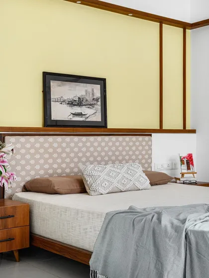 The 'Poorna' guest bedroom is vintage and earthy, with a custom bed and intersecting wooden ledges that create a unique architectural detail.