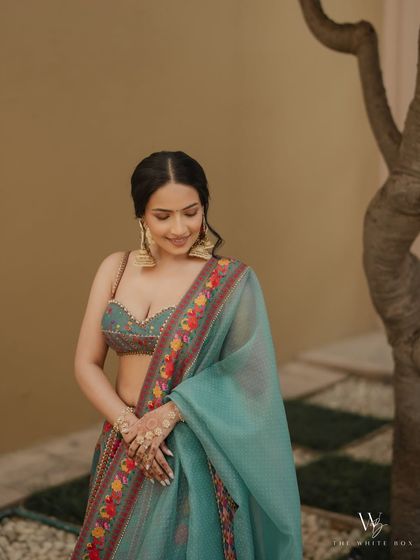 A soft and serene portrait of Shubhangi. The makeup is minimal, focusing on clean skin and subtly defined eyes.
