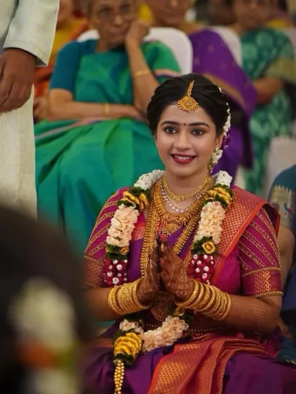 A candid moment during the wedding ceremony. The bride's makeup is kept classic and elegant, allowing her natural beauty and the richness of her culture to shine.
