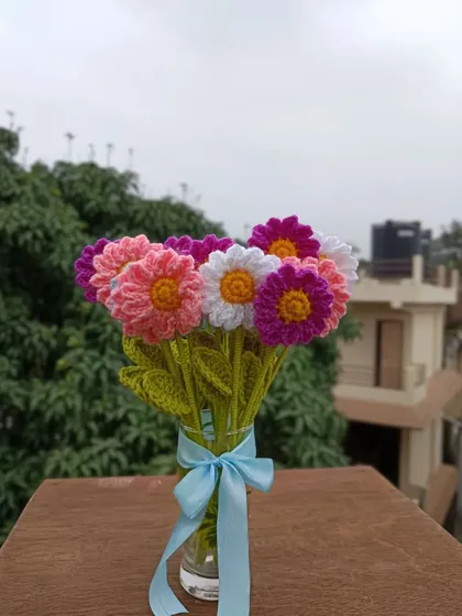 A mixed bouquet of colorful daisies in a vase.