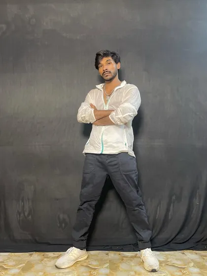A strong, confident pose against a black backdrop.