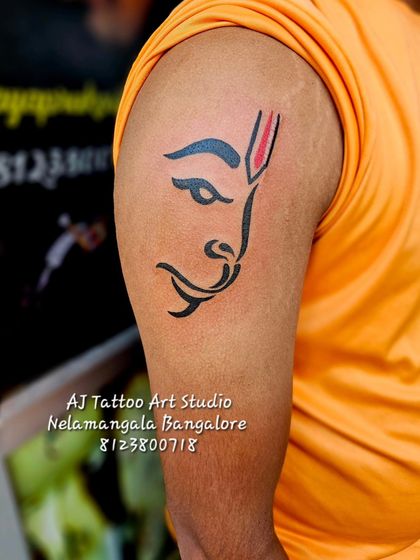 A minimalist yet powerful Hanuman tattoo on the upper arm. This design is simple, clean, and instantly recognizable.