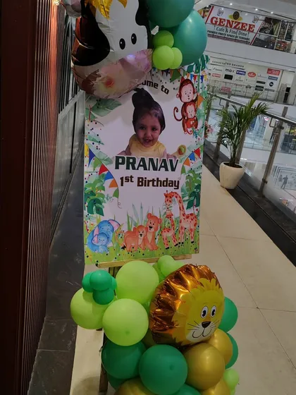 Another angle of the personalized welcome stand for Pranav's first birthday, showing the full design with lion and cow foil balloons.