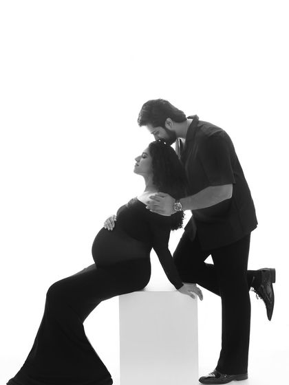 A moment of pure tenderness. His gentle kiss on her forehead in this black and white portrait is a simple, beautiful expression of love and care.