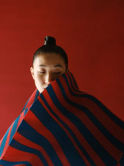 Another intimate shot from the Payal Khandwala series, where the model's face is partially obscured by the fabric, creating a sense of mystery and focusing on the textile's form.