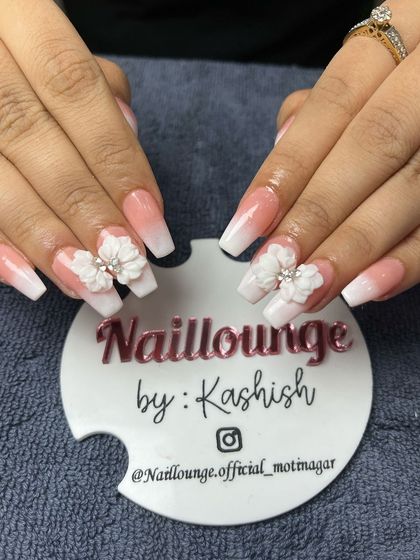 A classic white ombre on coffin nails, made special with beautiful 3D floral embellishments.