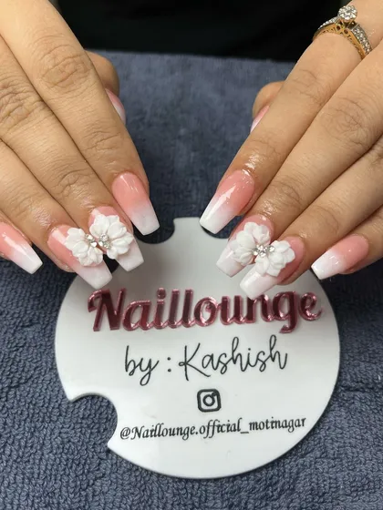 A classic white ombre on coffin nails, made special with beautiful 3D floral embellishments.