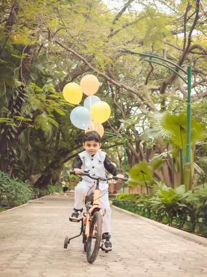 Another angle of this fun fourth birthday bike ride. The tree-lined path in this Bangalore park provides a stunning backdrop for action shots.