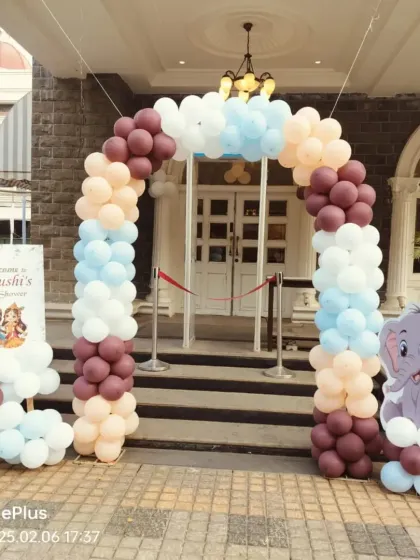 A welcoming balloon arch at the entrance of a baby shower venue. The pastel colors and elephant cutout create a sweet and inviting first impression for guests.