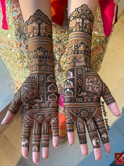 Another view of the short bridal mehendi, showing the beautiful composition against the bride's colorful lehenga.