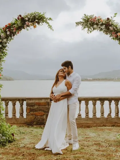 A beautiful pre-wedding portrait session by the lake, framed by a stunning floral arch. I love creating these grand, scenic shots that feel like a fairytale.