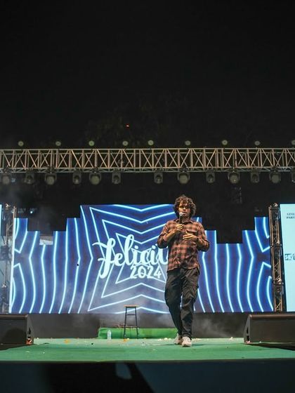 Joel D'souza walking onto the stage at the start of his comedy set.