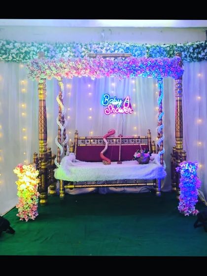 A wider view of the cherry blossom themed baby shower swing setup, perfect for creating a beautiful photo corner at your event.