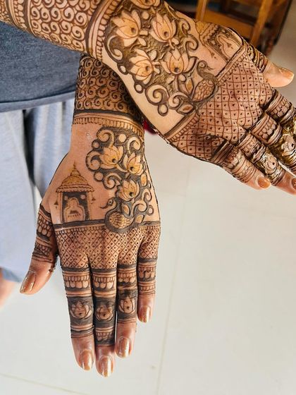 Here is a full view of a detailed design combining several elements. You can see a temple motif, lotus flowers, and peacock-inspired swirls, all tied together with intricate filler patterns.