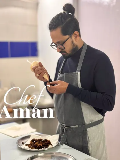 Meet Chef Aman, one of our founders, carefully plating a dish. His focus and artistry are at the core of our culinary philosophy.