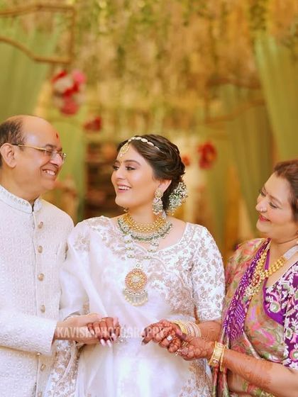 The bride shares a laugh with her parents, a perfect capture of family joy and connection during the wedding.
