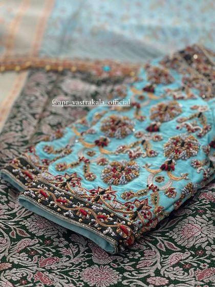 A close-up of the sleeve of the light blue blouse.