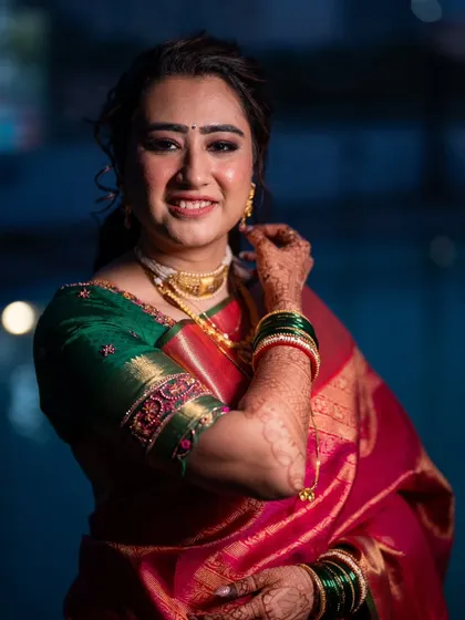 A stunning nighttime portrait of the bride. The makeup is soft and glowing, beautifully captured against the city lights.