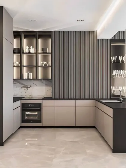This modern kitchen and utility space was designed for ultimate functionality and style. We used a combination of dark fluted panels and sleek, light-colored cabinets with integrated glass displays and backlighting to create a sophisticated and practical area.