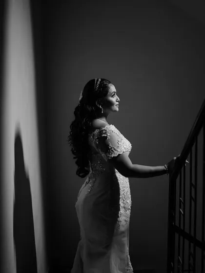 A stunning black and white photo that captures the timeless elegance of the bride's silhouette and hairstyle.
