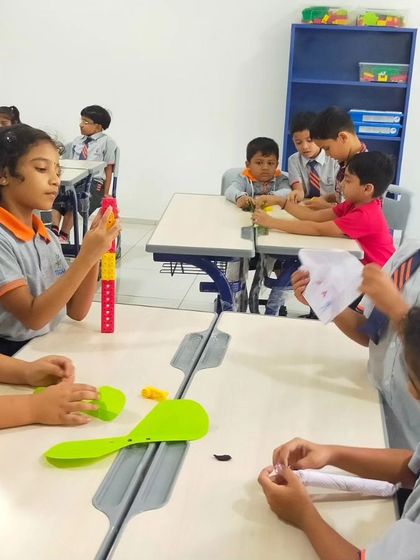 Students at The School for Global Minds explore concepts of balance and structure with simple machine kits. These foundational activities pave the way for more complex robotics projects.