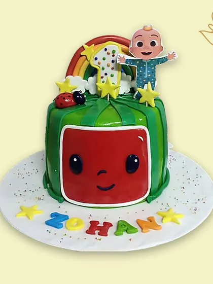 A cheerful Cocomelon cake for a first birthday. This colorful design features the iconic watermelon TV and JJ, ready for a sing-along celebration.