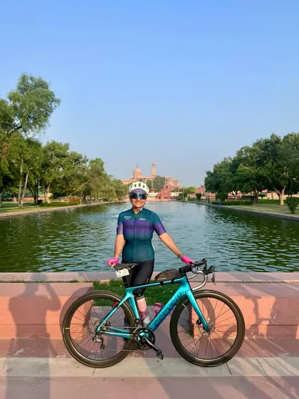 Posing by the water with her bike.